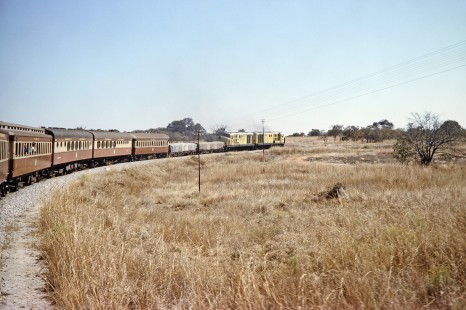 A National Railways of Zimbabwe train moves through a wide curve in Masvingo, Zimbabwe, on July 31, 1991. Photograph by Fred M. Springer, © 2014, Center for Railroad Photography and Art. Springer-Hedjaz-ZimZam(1)-16-12