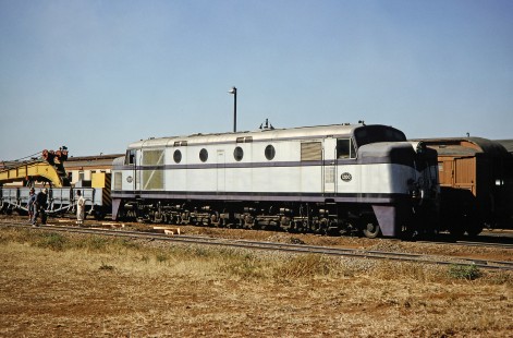 A group of workers look toward the camera and stand to the side of National Railways of Zimbabwe diesel locomotive no. 1200 in Bulawayo, Zimbabwe, on August 1, 1991. Photograph by Fred M. Springer, © 2014, Center for Railroad Photography and Art. Springer-Hedjaz-ZimZam(1)-18-12
