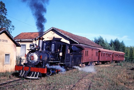 VFCO steam locomotive no. 60 carries passengers past several buildings in Antonio Carlos, Santa Catarina, Brazil, on May 30, 1976. Photograph by Fred M. Springer, © 2014, Center for Railroad Photography and Art. Springer-PA-BR-SOAM-ME-ARG2-10-02