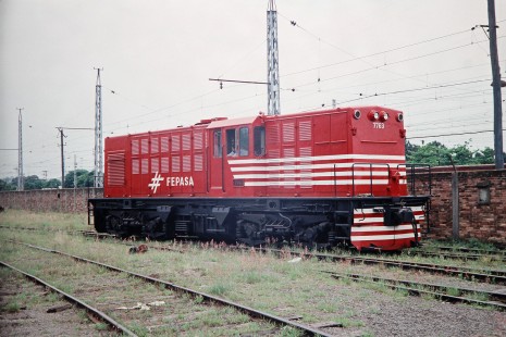 Ferrovia Paulista S.A. (later merged with RFFSA) diesel locomotive no. 7763 waits by a brick yard wall in Paulista, Sao Paulo, Brazil, on October 31, 1990. Photograph by Fred M. Springer, © 2014, Center for Railroad Photography and Art. Springer-PA-BR-SOAM-ME-ARG2-07-15