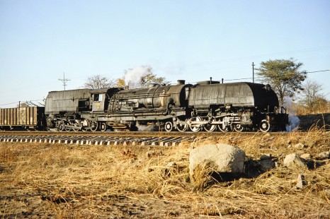 A sunny side view of National Railways of Zimbabwe Garratt steam locomotive no. 743 in Hwange, Matabeleland, Zimbabwe, on August 6, 1991. Photograph by Fred M. Springer, © 2014, Center for Railroad Photography and Art. Springer-Hedjaz-ZimZam(1)-24-33