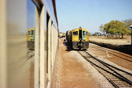 Two National Railways of Zimbabwe pass each other, highlighting a regular day in Masvingo, Zimbabwe, on July 31, 1991. Photograph by Fred M. Springer, © 2014, Center for Railroad Photography and Art. Springer-Hedjaz-ZimZam(1)-16-08