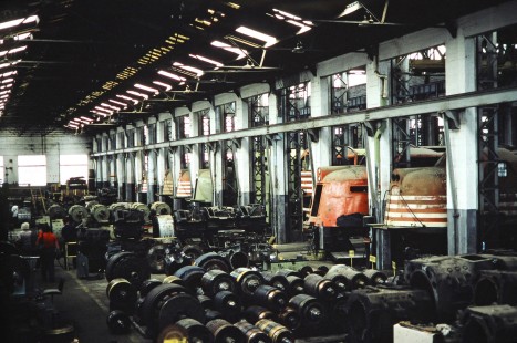 Interior view of the Ferrovia Paulista S.A. (later merged with RFFSA) shop where electric locomotives sit with parts in Paulista, Sao Paulo, Brazil, on October 31, 1990. Photograph by Fred M. Springer, © 2014, Center for Railroad Photography and Art. Springer-PA-BR-SOAM-ME-ARG2-07-22