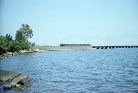 Rede Ferroviária Federal S.A. 2-10-2 steam locomotive no. 207 is seen in the distance along the Laguna bridge in Cascadura, Rio De Janeiro, Brazil on October 30, 1990. Photograph by Fred M. Springer, © 2014, Center for Railroad Photography and Art. Springer-PA-BR-SOAM-ME-ARG2-06-16