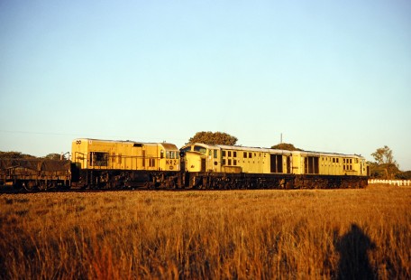 Three National Railways of Zimbabwe locomotives and a cargo car are captured by the photographer in Masvingo, Zimbabwe, on July 31, 1991. Photograph by Fred M. Springer, © 2014, Center for Railroad Photography and Art. Springer-Hedjaz-ZimZam(1)-15-31