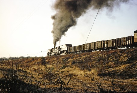 A National Railways of Zimbabwe Garratt  steam locomotive in Matetsi, Zimbabwe on August 6, 1991. Photograph by Fred M. Springer, © 2014, Center for Railroad Photography and Art. Springer-ZimZam(2)-Swiss-19-28