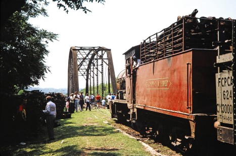 Ferrocarril Presidente Carlos Antonio López (later Ferrocarriles del Paraguay SA FEPASA) steam locomotive no. 59 prepares to cross a bridge after the crowd takes pictures and observes the scenery of Paraguay, on October 21, 1991. Photograph by Fred M. Springer, © 2014, Center for Railroad Photography and Art. Springer-ARG-PA-CHI-BO2-04-14