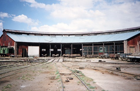 A wide shot of the Empresa Nacional de Ferrocarriles Bolivia 9-stall roundhouse and turntable. A Hunslet locomotive is also visible on the left in Viacha, Ingavi, Bolivia, on September 30, 1992. Photograph by Fred M. Springer, © 2014, Center for Railroad Photography and Art. Springer-ARG-PA-CHI-BO2-13-23