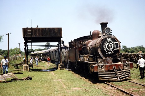 Ferrocarril Presidente Carlos Antonio López (later Ferrocarriles del Paraguay SA FEPASA) steam locomotive no. 59 receives water from a nearby tank and people observe the train in Grac Artigas, Paraguay, on October 21, 1991. Photograph by Fred M. Springer, © 2014, Center for Railroad Photography and Art. Springer-ARG-PA-CHI-BO2-04-17