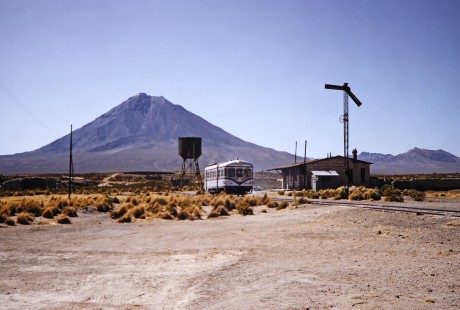 Empresa Nacional de Ferrocarriles Bolivia railcar no. M323 on a trip between Bolivia and Chile and is seen against a single towering mountain in the area of Humapacca, Pedro Domingo Murillo, Bolivia, on October 2, 1992. Photograph by Fred M. Springer, © 2014, Center for Railroad Photography and Art. Springer-ARG-PA-CHI-BO2-15-17