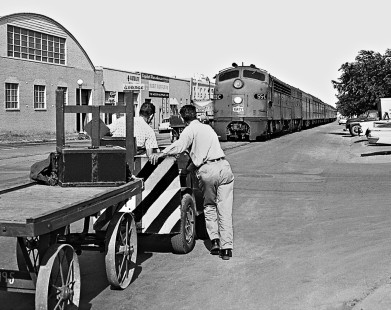 Baggage handlers await arrival of southbound Missouri–Kansas–Texas Railroad <i>Texas Special</i> passenger train at station in Austin, Texas, in July 1964. Photograph by J. Parker Lamb, © 2016, Center for Railroad Photography and Art. Lamb-02-040-04