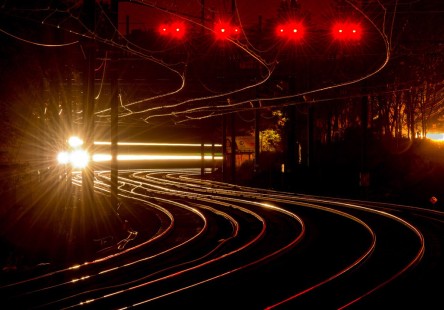 The headlights of northbound Amtrak Northeast Regional train shine along the Northeast Corridor at Metropark, New Jersey, on the night of September 19, 2014.

Read more about the <a href="http://www.railphoto-art.org/awards/2017-awards/" rel="nofollow">2017 John E. Gruber Creative Photography Awards Program</a>.