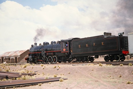 A back angle shot of Empresa Nacional de Ferrocarriles Bolivia 2-10-2 steam locomotive no. 704 as it approaches an outpost near Querqueta, Western Bolivia, Bolivia, on September 30, 1992. Photograph by Fred M. Springer, © 2014, Center for Railroad Photography and Art. Springer-ARG-PA-CHI-BO2-13-36