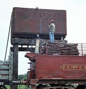 A worker activates the water tank for Ferrocarril Presidente Carlos Antonio López (later Ferrocarriles del Paraguay SA FEPASA) steam locomotive no. 151 in Carmen del Paraná, Itapúa, Paraguay, on October 23, 1990. Photograph by Fred M. Springer, © 2014, Center for Railroad Photography and Art. Springer-SOAM1-24-29