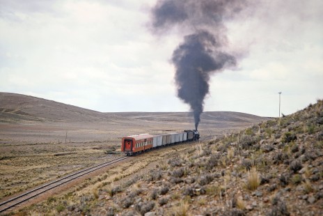 Smoke fills the air as Empresa Nacional de Ferrocarriles Bolivia 2-10-2 steam locomotive no. 704 follows the curve of the track near Capiri, Western Boliva, Bolivia, on September 30, 1992. Photograph by Fred M. Springer, © 2014, Center for Railroad Photography and Art. Springer-ARG-PA-CHI-BO2-13-32