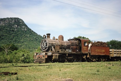 Ferrocarril Presidente Carlos Antonio López (later Ferrocarriles del Paraguay SA FEPASA) steam locomotive no. 151 stands next to a cliffside in Paraguari, Asunción, Paraguay, on October 22, 1991. Photograph by Fred M. Springer, © 2014, Center for Railroad Photography and Art. Springer-ARG-PA-CHI-BO2-06-32