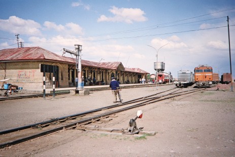 Viacha station is full of people and locomotives including Empresa Nacional de Ferrocarriles Bolivia diesel locomotive no. DE 1011 in Viacha, Ingavi, Bolivia, on September 30, 1992. Photograph by Fred M. Springer, © 2014, Center for Railroad Photography and Art. Springer-ARG-PA-CHI-BO2-13-16