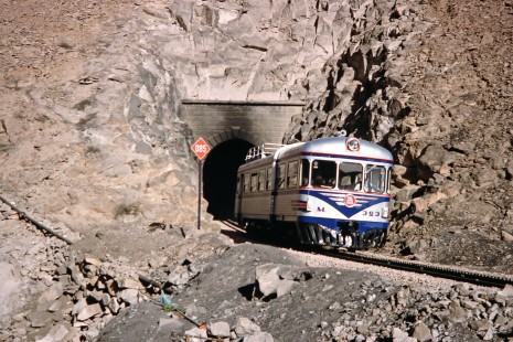 Empresa Nacional de Ferrocarriles Bolivia railcar no. M323 exits a tunnel as it travels between from La Paz, Pedro Domingo Murillo, Bolivia, to Arica, Arica, Chile, on October 2, 1992. Photograph by Fred M. Springer, © 2014, Center for Railroad Photography and Art. Springer-ARG-PA-CHI-BO2-15-09