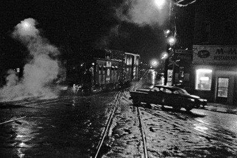 On a rainy night in Parkersburg, West Virginia, a Baltimore & Ohio eastbound freight train leaves town. Photographer David T. Mainey was working for the railroad as a Technical Trainee at the time and used a Leica IIIC camera. 

Read more about the <a href="http://www.railphoto-art.org/awards/2017-awards/" rel="nofollow">2017 John E. Gruber Creative Photography Awards Program</a>.