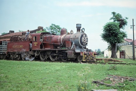 A rail worker looks on as Ferrocarril Presidente Carlos Antonio López (later Ferrocarriles del Paraguay SA FEPASA) steam locomotive no. 151 rolls into the city of Carmen del Paraná, Itapúa, Paraguay, on October 23, 1990. Photograph by Fred M. Springer, © 2014, Center for Railroad Photography and Art. Springer-SOAM1-24-25