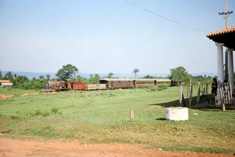 Ferrocarril Presidente Carlos Antonio López (later Ferrocarriles del Paraguay SA FEPASA) steam locomotive no. 151 is watched by a young girl resting in the shade in Pirayú, Paraguarí, Paraguay, on October 22, 1991. Photograph by Fred M. Springer, © 2014, Center for Railroad Photography and Art. Springer-ARG-PA-CHI-BO2-06-24