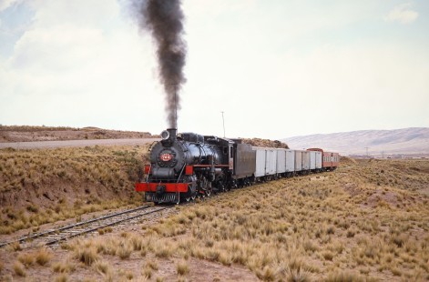 Empresa Nacional de Ferrocarriles Bolivia 2-10-2 steam locomotive no. 704 moves on a track next to a road in Querqueta, Western Bolivia, Bolivia, on September 30, 1992. Photograph by Fred M. Springer, © 2014, Center for Railroad Photography and Art. Springer-ARG-PA-CHI-BO2-12-02