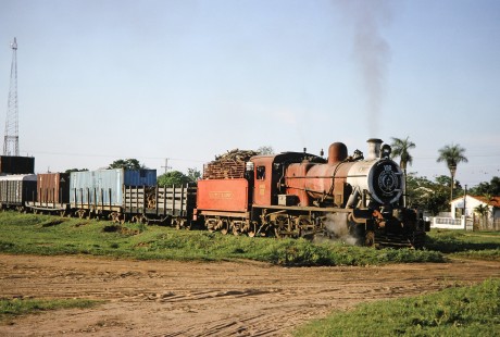 Ferrocarril Presidente Carlos Antonio López (later Ferrocarriles del Paraguay SA FEPASA) steam locomotive no. 152 moves through a residential area in Ypacaraí, Central, Paraguay, on October 22, 1991. Photograph by Fred M. Springer, © 2014, Center for Railroad Photography and Art. Springer-ARG-PA-CHI-BO2-06-14