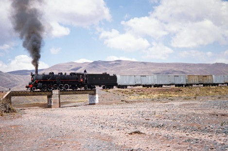 Heading north of Guaqui, Empresa Nacional de Ferrocarriles Bolivia 2-10-2 steam locomotive no. 704 crosses over a small bridge in Arroyo, Western Bolivia, Bolivia, on September 30, 1992. Photograph by Fred M. Springer, © 2014, Center for Railroad Photography and Art. Springer-ARG-PA-CHI-BO2-12-13