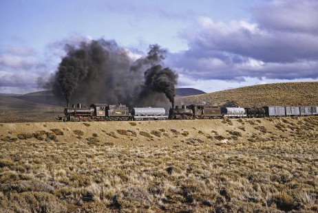 Viejo Expreso Patagónico (Old Pagagonian Express) double header freight train led by steam locomotive nos. 114 and 6 at kilometer post 330 in Lepa, Chubut, Argentina, on October 12, 1991. Photograph by Fred M. Springer, © 2014, Center for Railroad Photography and Art, Springer-PA-BR-SOAM-ME-ARG2-21-22