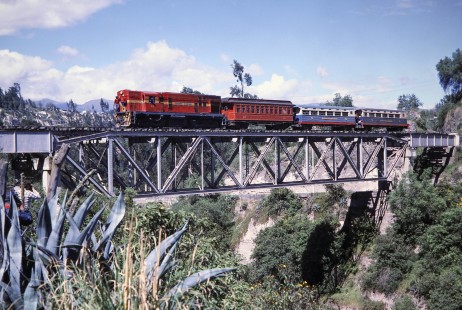 Empresa de Ferrocarriles Ecuatorianos diesel locomotive no. 164 and a passenger train crosses the high bridge at Ambato, Tungurahua, Ecuador, on July 27, 1988. Photograph by Fred M. Springer, © 2014, Center for Railroad Photography and Art, Springer-ECU1-12-05