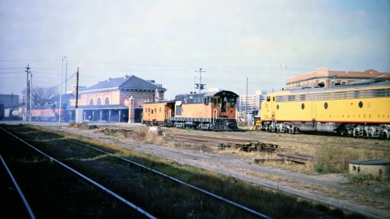 Milwaukee Road locomotives at the depot in Madison, Wisconsin, on November 2, 1968. GP9s nos. 261 and 264 are heading the daily freight train for Portage, Fairbanks-Morse switcher no. 778 rests with a caboose, and E9 no. 38A heads a football special passenger train from Milwaukee, in town for the University of Wisconsin game with Indiana. The Badgers' 20-21 loss to the Hoosiers was the closest they would come to victory in 1968's winless campaign. Photograph by Thomas F. McIlwraith, McIlwraith-01-025-02, © 2018, Center for Railroad Photography & Art, <a href="http://www.railphoto-art.org" rel="noreferrer nofollow">www.railphoto-art.org</a>