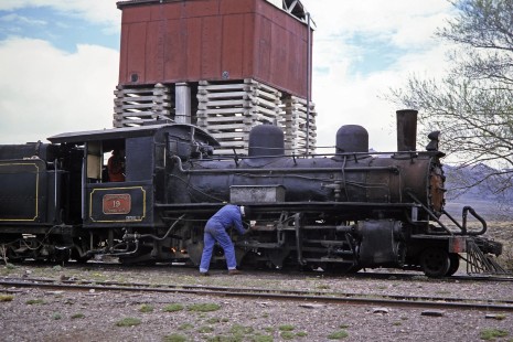 A worker inspects Viejo Expreso Patagónico (Old Patagonian Express) steam locomotive no. 19 at Fitalancao, Chubut, Argentina, on October 31, 1995.  © 2014, Center for Railroad Photography and Art, Photograph by Fred M. Springer. Springer-CHI-ARG1-12-01