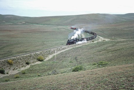 Ramal Ferro Industrial de Río Turbio steam locomotive no. 118 pushes its freight cargo on a curved track at Corue kilometer post 37 in Río Turbio, Santa Cruz, Argentina, on October 17, 1990. Photograph by Fred M. Springer © 2014, Center for Railroad Photography and Art, Springer-SOAM1-18-29