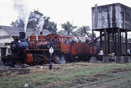 Guayaquil-Quito Railway steam locomotive no. 11 at a water tower in Milagro, Guayas, Ecuador, on July 22, 1988. Photograph by Fred M. Springer,  © 2014, Center for Railroad Photography and Art, Springer-ECU1-02-25
