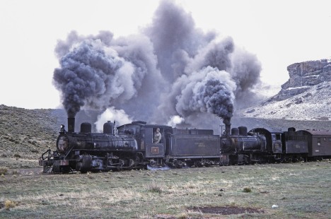 Viejo Expreso Patagónico (Old Patagonian Express) steam locomotives nos. 6 and 115 lead passenger train near Ñorquinco, Río Negro, Argentina, on October 14, 1991. Photograph by Fred M. Springer. © 2014, Center for Railroad Photography and Art, Springer-PA-BR-SOAM-ME-ARG2-22-06
