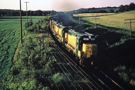 Chicago and North Western Railway GP30 diesel locomotive no. 810 leading a freight train from Minneapolis to Chicago near Oregon, Wisconsin, on Monday, July 24, 1967. The view is from the Dane County Road "M" overpass. Photograph by Thomas F. McIlwraith, McIlwraith-01-011-08, © 2018, Center for Railroad Photography & Art, <a href="http://www.railphoto-art.org" rel="noreferrer nofollow">www.railphoto-art.org</a>