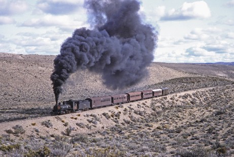Viejo Expreso Patagónico (Old Patagonian Express) steam locomotive no. 4 hauls passenger train at kilometer post 114.5 in Cerro Mesa, Río Negro, Argentina, on October 15, 1991. Photograph by Fred M. Springer. © 2014, Center for Railroad Photography and Art, Springer-PA-BR-SOAM-ME-ARG2-24-13
