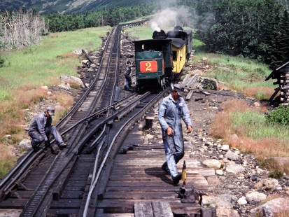 On New Hampshire's Mount Washington Cog Railway, two uphill trains prepare to back out of Waumbek Siding to continue their journeys to the summit after meeting a downhill train on July 27, 1983. Photograph by Thomas F. McIlwraith, McIlwraith-01-038-13, © 2018, Center for Railroad Photography & Art, <a href="http://www.railphoto-art.org" rel="noreferrer nofollow">www.railphoto-art.org</a>