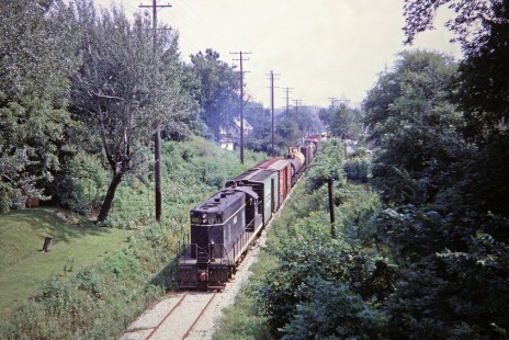 Illinois Central Railroad GP7 diesel locomotive no. 8851 leading a local freight train out of Madison, Wisconsin, on Friday, August 16, 1968. The Wisconsin State Capitol is visible in the distance; this line is now a bike trail. Photograph by Thomas F. McIlwraith, McIlwraith-01-024-01, © 2018, Center for Railroad Photography & Art, <a href="http://www.railphoto-art.org" rel="noreferrer nofollow">www.railphoto-art.org</a>