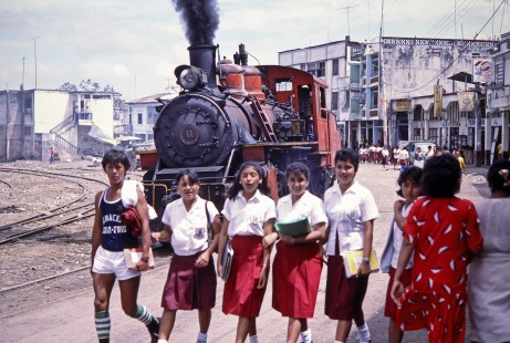 School children walk near Guayaquil-Quito Railway steam locomotive no. 11 hauls freight train in Bucay, Chimborazo, Ecuador, on August 2, 1988. Photograph by Fred M. Springer, © 2014, Center for Railroad Photography and Art, Springer-ECU1-19-18