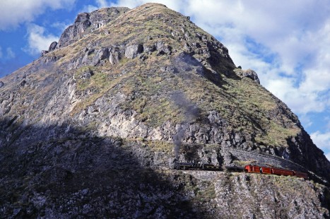 Guayaquil-Quito Railway steam locomotive no. 44 leads passenger train on the Nariz del Diablo (Devil's Nose) near Alausi, Chimborazo, Ecuador, on either July 23, 1988. Photograph by Fred M. Springer, © 2014, Center for Railroad Photography and Art, Springer-ECU1-06-23
