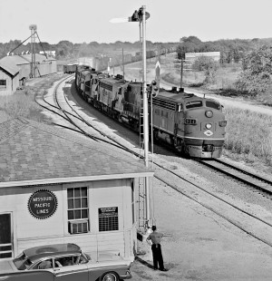 Operator at station in Round Rock, Texas, greets crew of southbound Missouri Pacific Railroad freight train in May 1964. Photograph by J. Parker Lamb, © 2016, Center for Railroad Photography and Art. Lamb-02-062-01