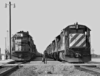 Southbound Atchison, Topeka and Santa Fe Railway freight train prepares to depart yard at Temple, Texas, as crew member of coal train with Burlington Northern power heads to cab in July 1970. Photograph by J. Parker Lamb, © 2016, Center for Railroad Photography and Art. Lamb-02-067-10