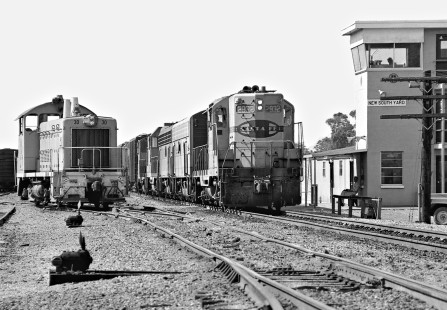 Southbound Atchison, Topeka and Santa Fe Railway freight train enters New South Yard in Houston, Texas, during February 1978 in a northerly direction, a quirk due to the early construction of the Gulf, Colorado and Santa Fe Railroad, which had no corporate connection to the ATSF until later years. Photograph by J. Parker Lamb, © 2016, Center for Railroad Photography and Art. Lamb-02-068-08