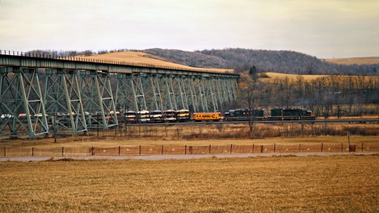 Helper locomotives pushing an eastbound Baltimore and Ohio Railroad freight train underneath the Salisbury Viaduct in Meyersdale, Pennsylvania, on March 22, 1975. Photograph by John F. Bjorklund, © 2016, Center for Railroad Photography and Art. Bjorklund-92-14-11