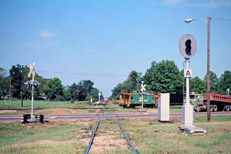 Burlington Northern caboose on a northbound Kansas City Southern Railway coal train with a waiting St. Louis-San Francisco Railway train at Ashdown, Arkansas, on July 22, 1977. Photograph by John F. Bjorklund, © 2016, Center for Railroad Photography and Art. Bjorklund-61-21-01
