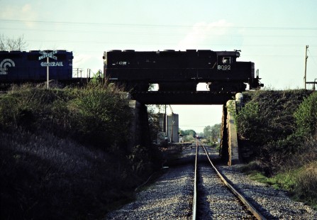 Eastbound Conrail and southbound Detroit, Toledo and Ironton (in the distance) freight trains in St. Paris, Ohio, on May 8, 1982. Photograph by John F. Bjorklund, © 2016, Center for Railroad Photography and Art. Bjorklund-52-12-05