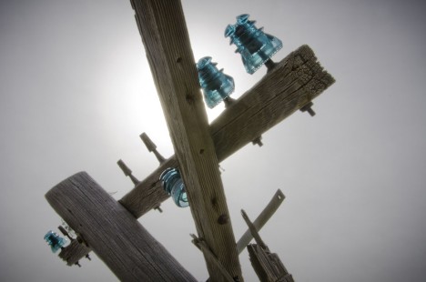 Telephone pole with glass insulators along the Kyle Railroad on the former Rock Island main line at Brewster, Kansas, in March 2013.