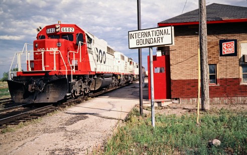 Westbound Soo Line Railroad freight train at the U.S.-Canadian border in Portal, North Dakota, on July 5, 1980. Photograph by John F. Bjorklund, © 2016, Center for Railroad Photography and Art. Bjorklund-83-23-04