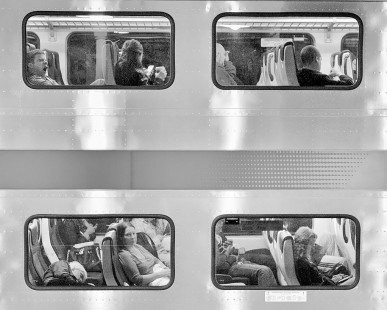 "Late Commute." Commuters framed in the windows of an NJ Transit double-deck passenger car at the Broad Street Station in Newark, New Jersey, on May 2, 2012. The photographer used NIK Silver Efex 2 Pro to convert the color digital image to black-and-white.